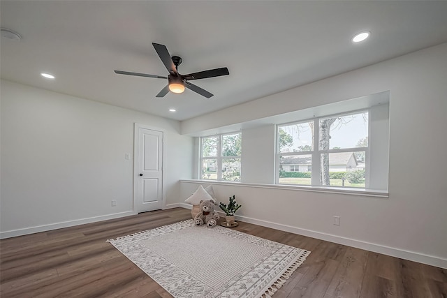 interior space featuring baseboards, dark wood-style flooring, and recessed lighting