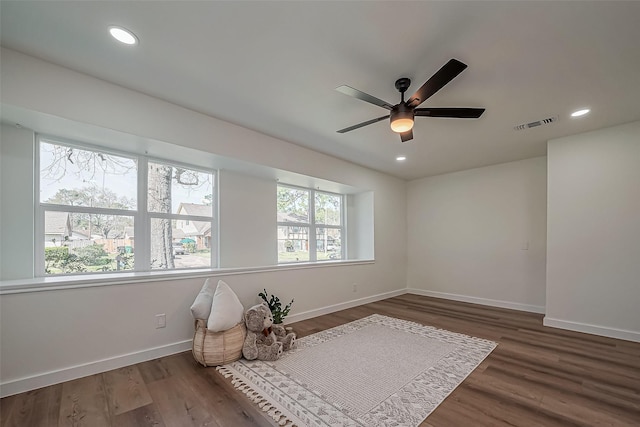 interior space featuring wood finished floors and recessed lighting