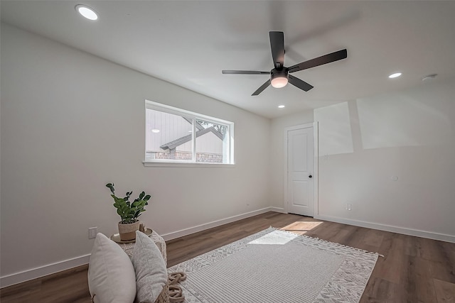 living area with recessed lighting, baseboards, and wood finished floors