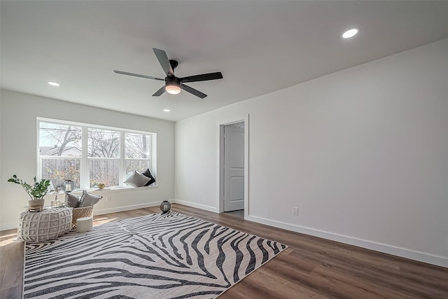 sitting room with dark wood-type flooring, recessed lighting, and baseboards