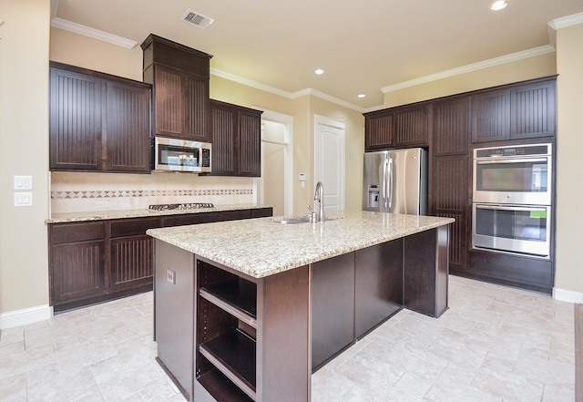 kitchen featuring a center island with sink, open shelves, visible vents, appliances with stainless steel finishes, and dark brown cabinetry