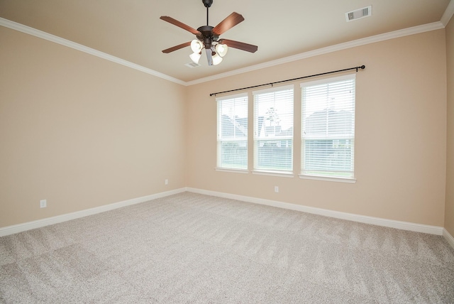 unfurnished room featuring carpet floors, visible vents, crown molding, and baseboards