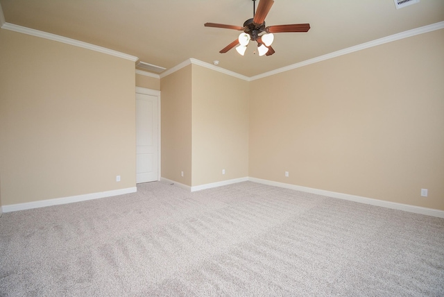 unfurnished room featuring ceiling fan, light colored carpet, visible vents, baseboards, and ornamental molding