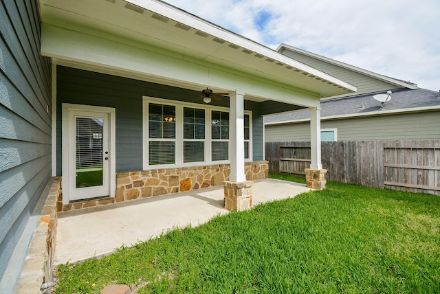 exterior space with fence and a ceiling fan