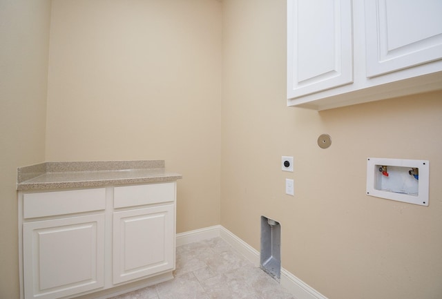 clothes washing area featuring hookup for a washing machine, cabinet space, electric dryer hookup, and baseboards