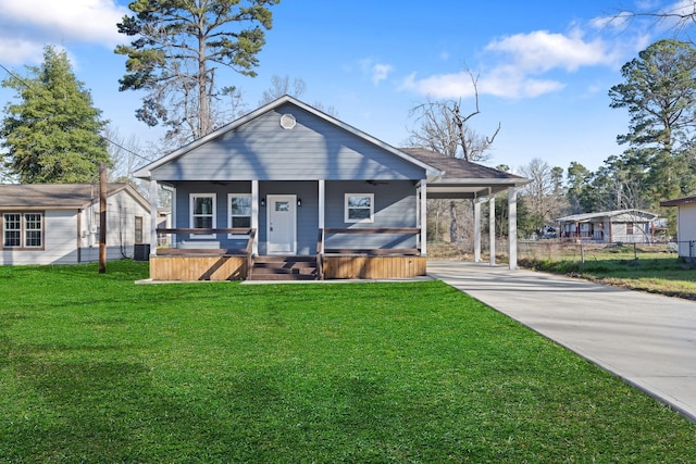 bungalow-style home with central air condition unit, concrete driveway, a hot tub, a front yard, and an attached carport