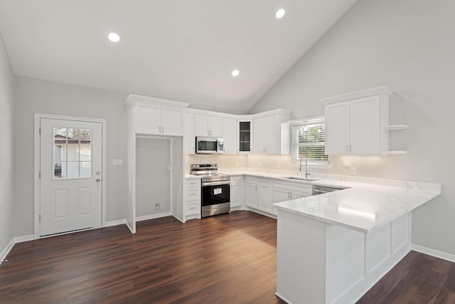 kitchen with open shelves, appliances with stainless steel finishes, white cabinetry, a sink, and a peninsula