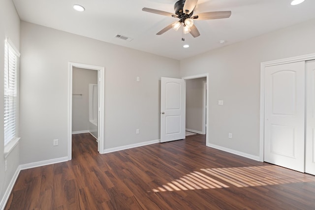 unfurnished bedroom featuring a closet, visible vents, baseboards, and wood finished floors