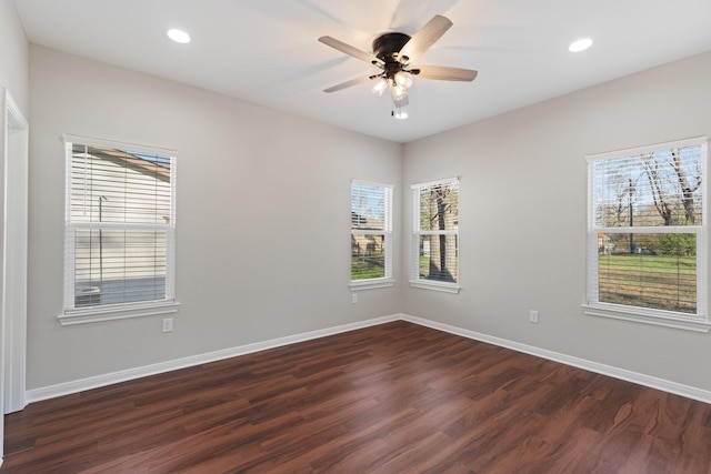 empty room with dark wood-type flooring, recessed lighting, ceiling fan, and baseboards