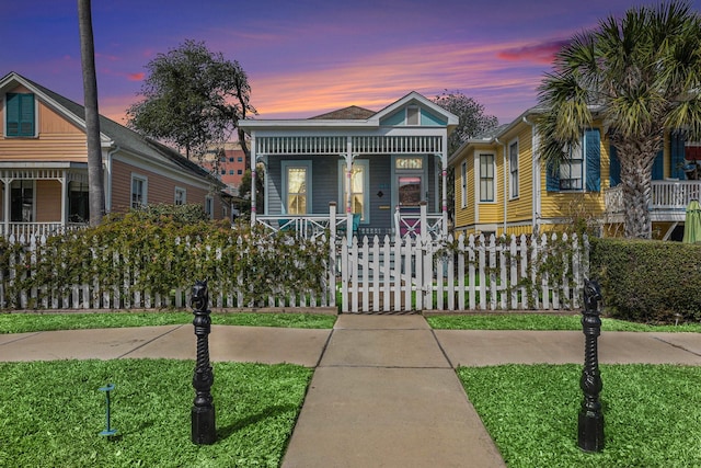 view of front of home featuring a porch and fence