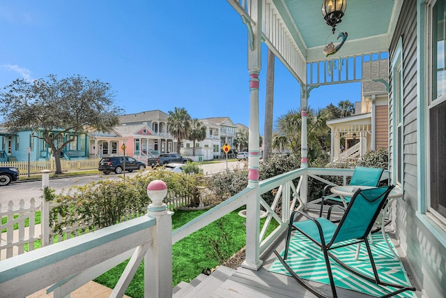 balcony with covered porch and a residential view