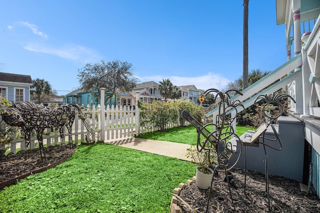 view of yard featuring a residential view and fence