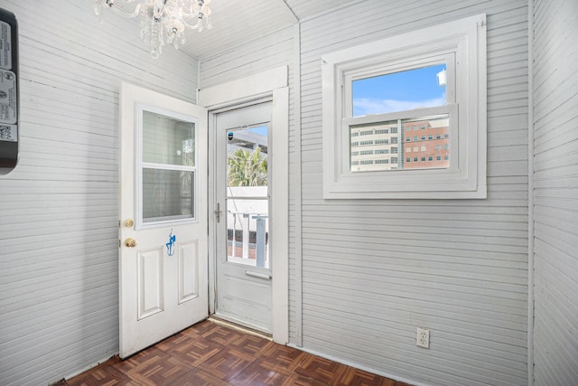 doorway featuring a notable chandelier