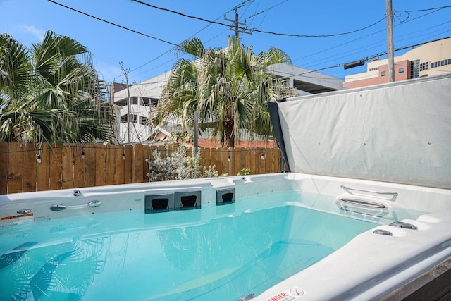 exterior space featuring a hot tub and fence