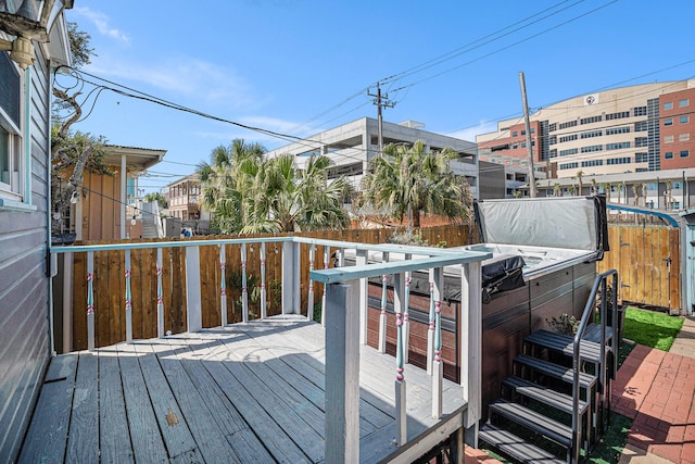 wooden terrace with fence and a hot tub