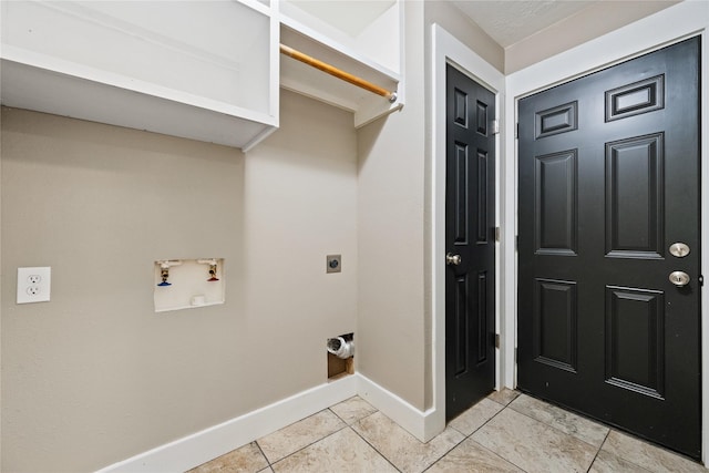 laundry area with light tile patterned flooring, baseboards, hookup for an electric dryer, hookup for a washing machine, and laundry area