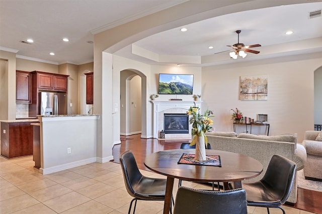 dining space featuring crown molding, a fireplace, recessed lighting, visible vents, and light tile patterned flooring