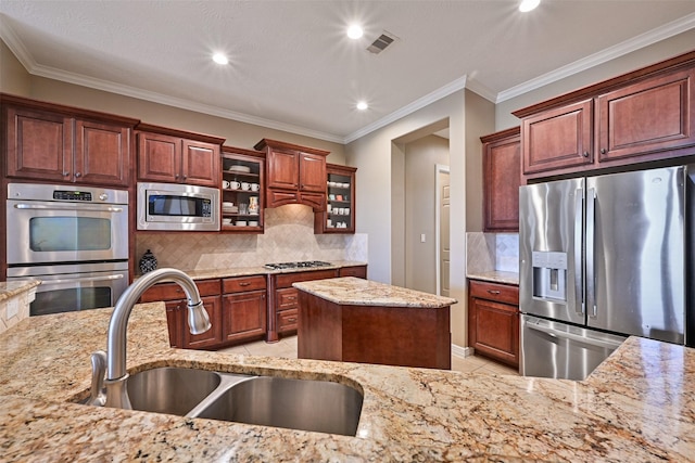 kitchen with light tile patterned floors, visible vents, light stone counters, stainless steel appliances, and a sink