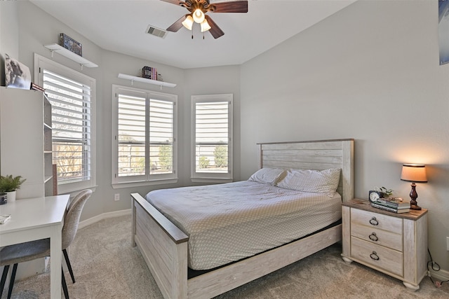 bedroom featuring a ceiling fan, light colored carpet, visible vents, and baseboards