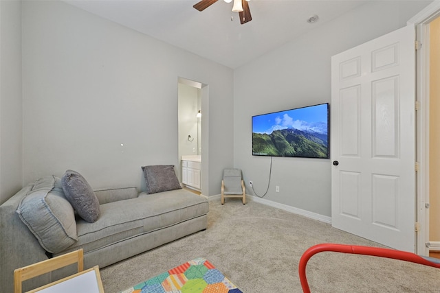 carpeted living room with a ceiling fan and baseboards