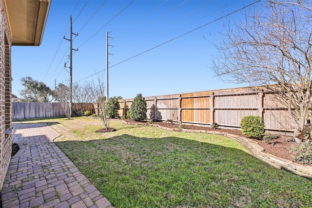 view of yard with a fenced backyard