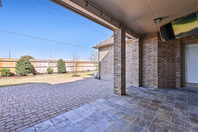 view of patio / terrace featuring fence