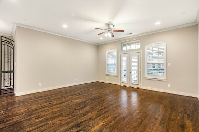 empty room with visible vents, dark wood finished floors, and crown molding