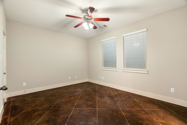 tiled empty room with visible vents, baseboards, and a ceiling fan