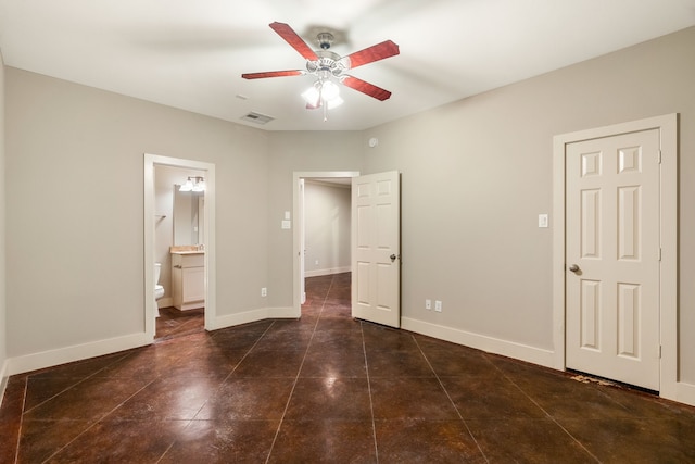 unfurnished bedroom featuring visible vents, ensuite bathroom, a ceiling fan, baseboards, and tile patterned floors