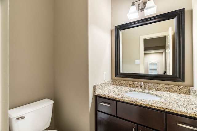 bathroom featuring toilet and vanity