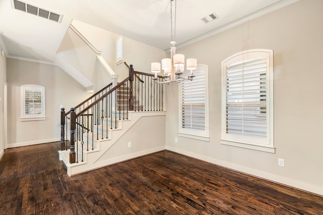 interior space with stairs, visible vents, a chandelier, and wood finished floors