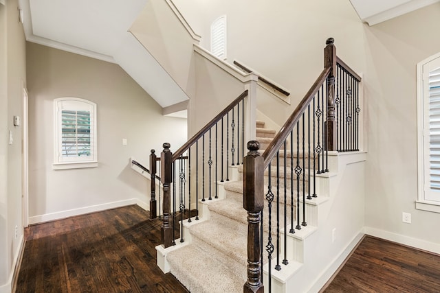 stairs featuring ornamental molding, wood finished floors, and baseboards