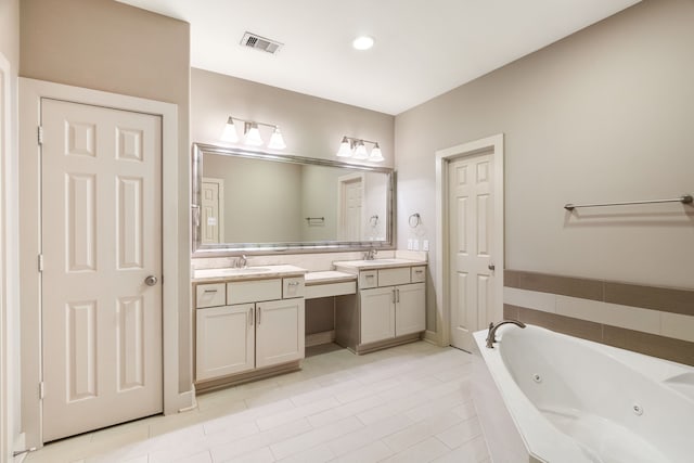 full bathroom with a jetted tub, vanity, and visible vents