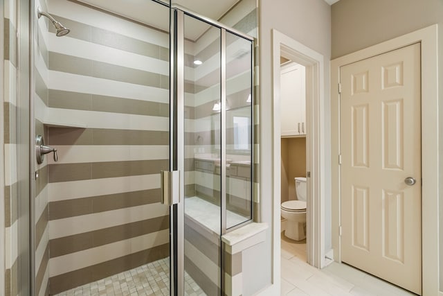 bathroom featuring a shower stall and toilet