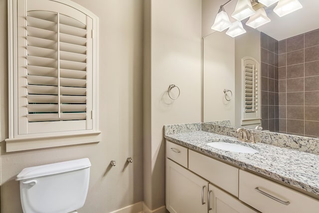 bathroom with toilet and vanity