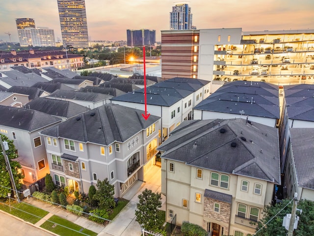 aerial view at dusk with a view of city and a residential view