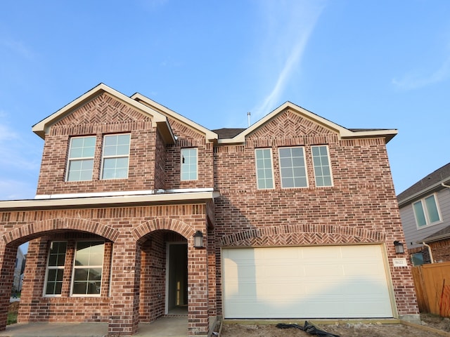 8622 Pier Cove Dr, Cypress, TX 77433 - view of front facade featuring brick siding, an attached garage, and driveway