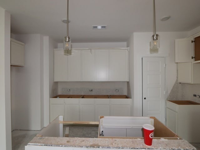 8622 Pier Cove Dr, Cypress, TX 77433 - kitchen with a center island, decorative light fixtures, and white cabinets
