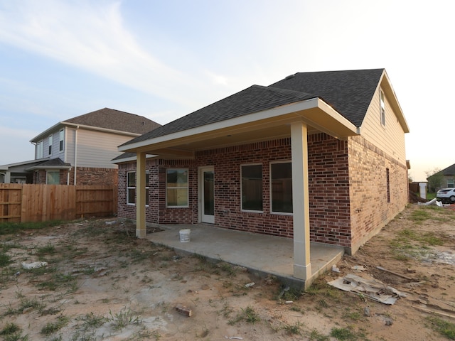 8622 Pier Cove Dr, Cypress, TX 77433 - back of house featuring brick siding, a patio, and roof with shingles