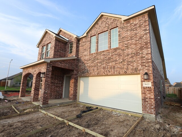 8622 Pier Cove Dr, Cypress, TX 77433 - view of front of home with brick siding, a garage, and driveway