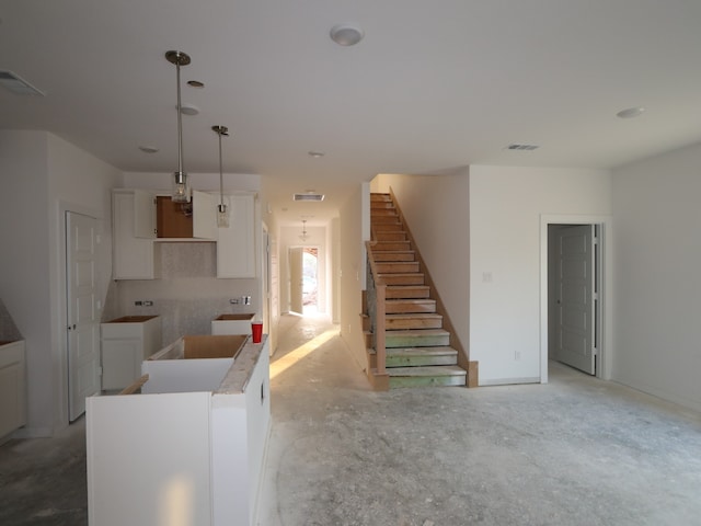 8622 Pier Cove Dr, Cypress, TX 77433 - kitchen with unfinished concrete floors, white cabinetry, and a kitchen island