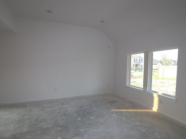 8622 Pier Cove Dr, Cypress, TX 77433 - unfurnished room featuring concrete flooring, lofted ceiling, and baseboards