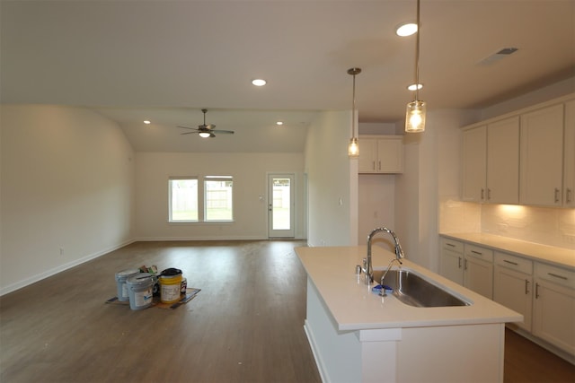 8622 Pier Cove Dr, Cypress, TX 77433 - kitchen featuring white cabinets, dark wood finished floors, ceiling fan, an island with sink, and recessed lighting