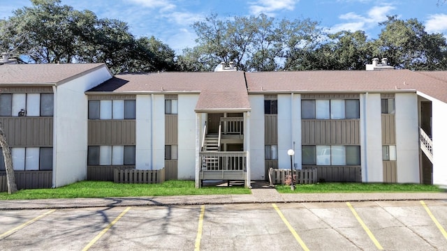 view of building exterior with uncovered parking