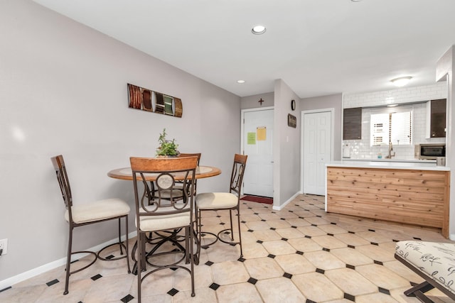 dining area featuring light floors, baseboards, and recessed lighting