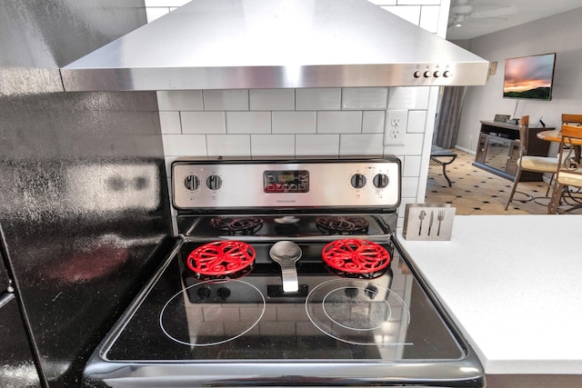 kitchen featuring a ceiling fan, stainless steel stove, and extractor fan