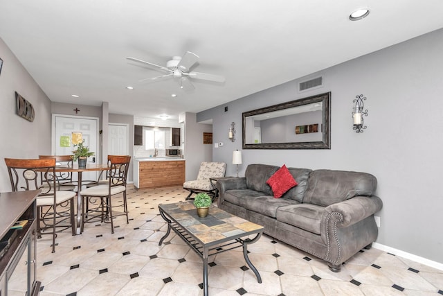 living area featuring baseboards, a ceiling fan, visible vents, and recessed lighting