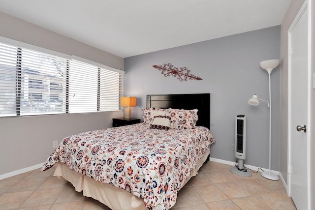 tiled bedroom featuring baseboards