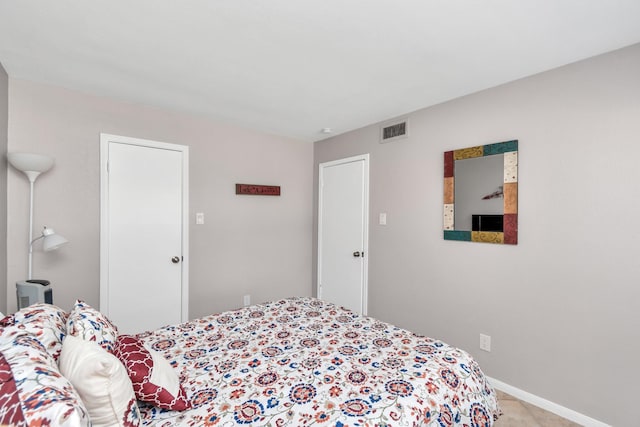 bedroom featuring visible vents and baseboards