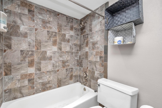 bathroom featuring washtub / shower combination and toilet